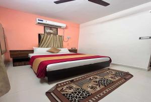 a bedroom with a bed and a rug at Hotel O Kurnool Railway Station Road in Kurnool