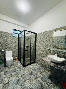 a bathroom with a sink and a toilet and a shower at Oasis Peak Ella in Ella +44 photos