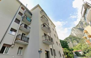 an apartment building with a view of the mountains at Apartment with a Mountain View in Lecco