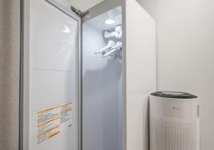 a shower with a glass door next to a fan at Lantana Daegu Shinam Branch in Daegu +31 photos