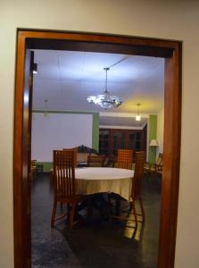 a dining room with a table and some chairs at Gilbys Eco Bungalow in Udaweliwitiya