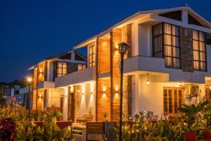 a house with a lit up facade at night at Goya Hills 3BHK - Private Villa Udaipur in Udaipur