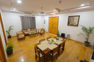 a living room with a table and chairs and a couch at Goya Hills 3BHK - Private Villa Udaipur in Udaipur