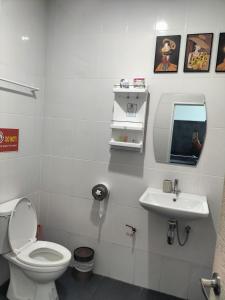 a bathroom with a toilet and a sink at Baan Seaview Sunset in Ko Lanta