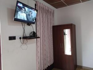a flat screen tv on the wall of a room at Lucknature Cabana Kandy in Elamalwewa