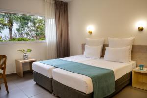 a hotel room with a large bed with a window at Jacob Ohalo Kinneret in Kinneret +90 photos