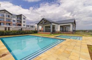 a large swimming pool in front of a building at AlimamaSpaces The Lavender in Northriding