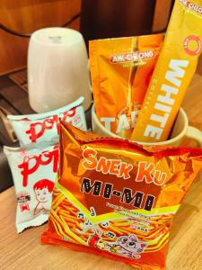 a pile of snacks sitting on a table at 118 Grand Hotel in George Town