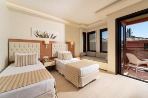 a hotel room with two beds and a balcony at Sundia By Liberty Suncity in Oludeniz +86 photos