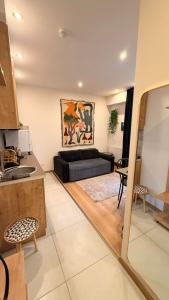 a living room with a couch and a table at Bakuriani valley Didveli in Bakuriani +8 photos