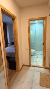 a bathroom with a door open to a bedroom with a tub at Bakuriani valley Didveli in Bakuriani