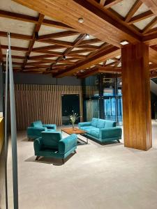 a living room with blue couches and a table at Bakuriani valley Didveli in Bakuriani