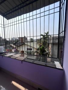 a large window with a view of a building at OhanaStay02 in Guwahati
