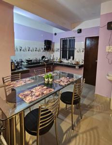 a kitchen with a table with food on it at OhanaStay02 in Guwahati