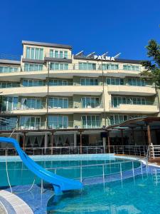 a hotel with a slide in a swimming pool at Hotel Pacific Palma in Sunny Beach