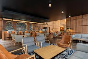 a restaurant with chairs and tables and a bar at Four Points by Sheraton Bangkok Ploenchit Sukhumvit in Bangkok