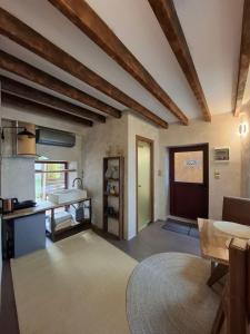 a living room with a table and a kitchen at Evanthia maisonette in Chalkida