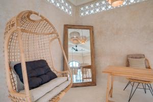 a room with a swing and a table and a mirror at South Villa Ungasan in Ungasan