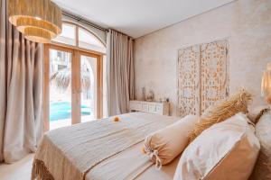 a bedroom with a large bed and a large window at South Villa Ungasan in Ungasan