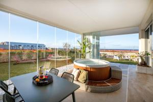 a living room with a hot tub and a table at Villa fronte mare in Bari