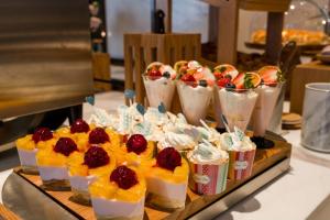 a tray of desserts on a buffet table at Atour Hotel Dalian Development Zone in Dalian