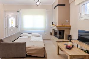 a living room with a couch and a fireplace at Afroditi's Delux apartment in Monemvasia