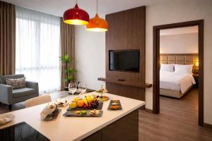 a hotel room with a table with fruit on it at Prime Istanbul Residences in Istanbul +32 photos