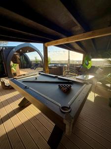 a pool table sitting on top of a deck at The Secret Garden Glamping Cornwall in Cury