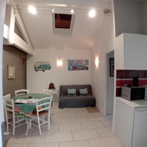 ein Wohnzimmer mit einem Tisch und einem Sofa in der Unterkunft Pinpirinia min 3 nuits in Guéthary