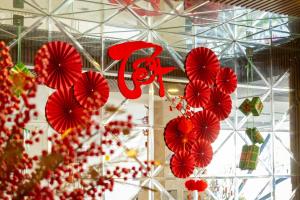 a bunch of red paper umbrellas hanging in a store at Gold Central Hotel by Haviland in Danang