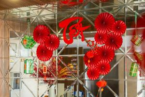 a bunch of red paper hearts hanging from a ceiling at Gold Central Hotel by Haviland in Danang +73 photos