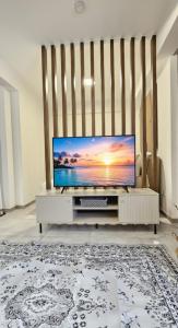 a living room with a flat screen tv on a table at Nala Host-Luxor studios in Male City