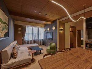 a living room with a couch and a table at illi Aest Shinagawa-Gotanda in Tokyo