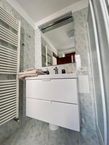 a bathroom with a white sink and a mirror at Casa Piccola in Tremosine Sul Garda