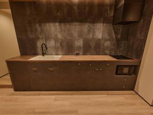 a kitchen with a sink and a counter top at illi Aest Shinagawa-Gotanda in Tokyo +61 photos