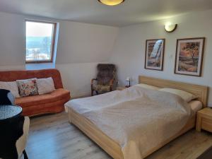 a bedroom with a bed and a couch and a chair at Sielanka pod Siglanami 2 in Wisła +27 photos