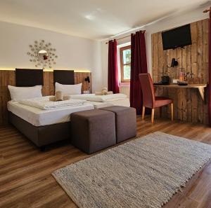 a bedroom with two beds and a chair and a table at Der Blankhof "Back to Roots" in Bad Endorf +73 photos