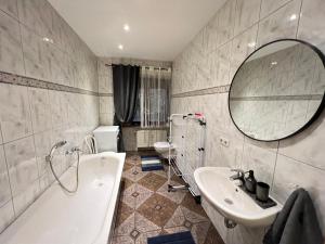 a bathroom with a tub and a sink and a mirror at Villa Louis Hirsch in Gera +67 photos