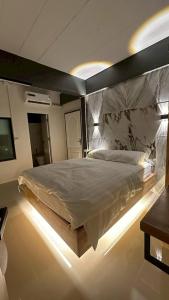 a bedroom with a large bed with lights on it at Villa Moon Terrace in Bang Khen +6 photos