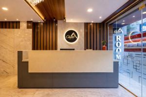 a reception desk in a lobby with aania sign at Hotel Chalet, Madiwala in Bangalore
