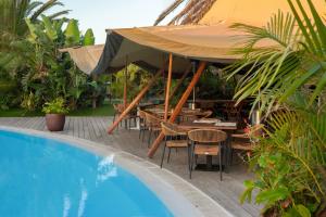 a patio with a table and chairs next to a pool at Villas Elements by Alondra in Puerto del Carmen