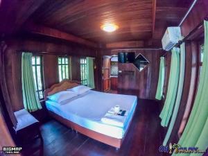 a bedroom with a bed in a wooden room at Oh Taley Resort in Rayong +104 photos