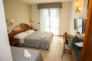 a hotel room with two beds and a television at ALI HOTELS - Palace in San Giovanni Rotondo +104 photos