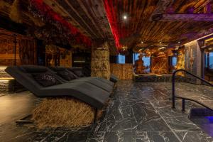 a living room with a couch and hay bales at Agate Resort & SPA in Mykulychyn