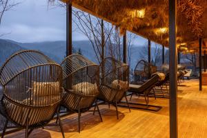a group of chairs sitting on top of a deck at Agate Resort & SPA in Mykulychyn