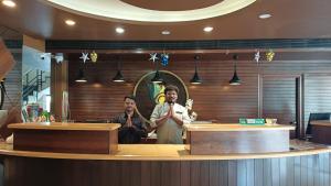 two men standing behind a counter in a restaurant at Hotel Sriram JB Residency in Virudunagar +60 photos