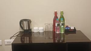 a table with several bottles and glasses on it at Hotel Sriram JB Residency in Virudunagar