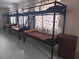 a couple of bunk beds in a room at The Rishi Van Dormitory, Khetri,Rajasthan,Farm No 52-55,Vally Drive,Retreat Nature Farms Society Complex in Khetri