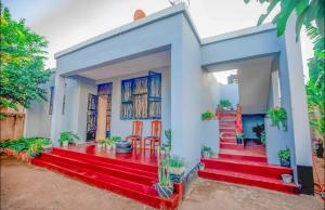 a house with red stairs in front of it at New Star House in Arusha