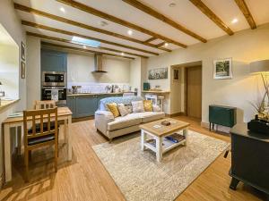 a living room with a couch and a table at Dragonfly Cottage-Uk39919 in Ballakinnag